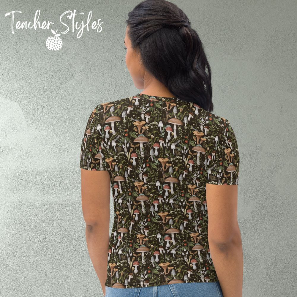 Fungi Fun T-shirt - brown by Teacher Styles. Model is shown from the waist up. T-shirt has brown background and pattern of forest mushrooms. back view