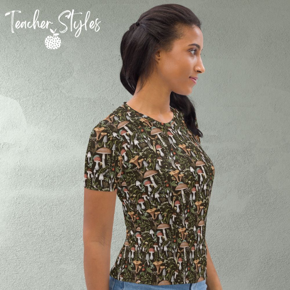 Fungi Fun T-shirt - brown by Teacher Styles. Model is shown from the waist up. T-shirt has brown background and pattern of forest mushrooms. side view