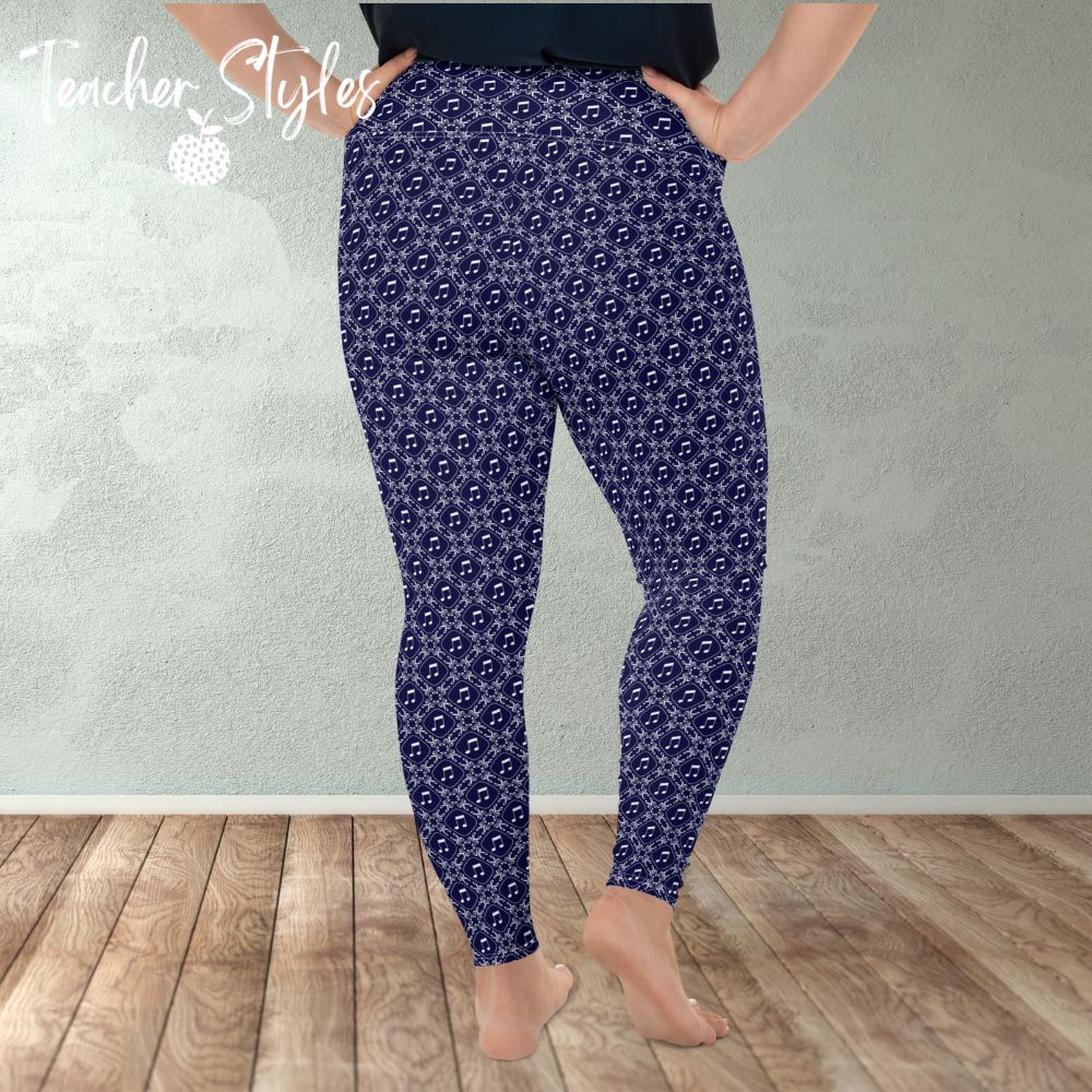 Musical Interlude plus size leggings by Teacher Syles. Model is shown from the waist down.  Leggings have deep blue background with white lattice pattern made of treble clefs. Musical notes in each treble square. back view