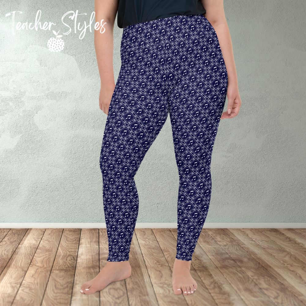 Musical Interlude plus size leggings by Teacher Syles. Model is shown from the waist down.  Leggings have deep blue background with white lattice pattern made of treble clefs. Musical notes in each treble square. front view