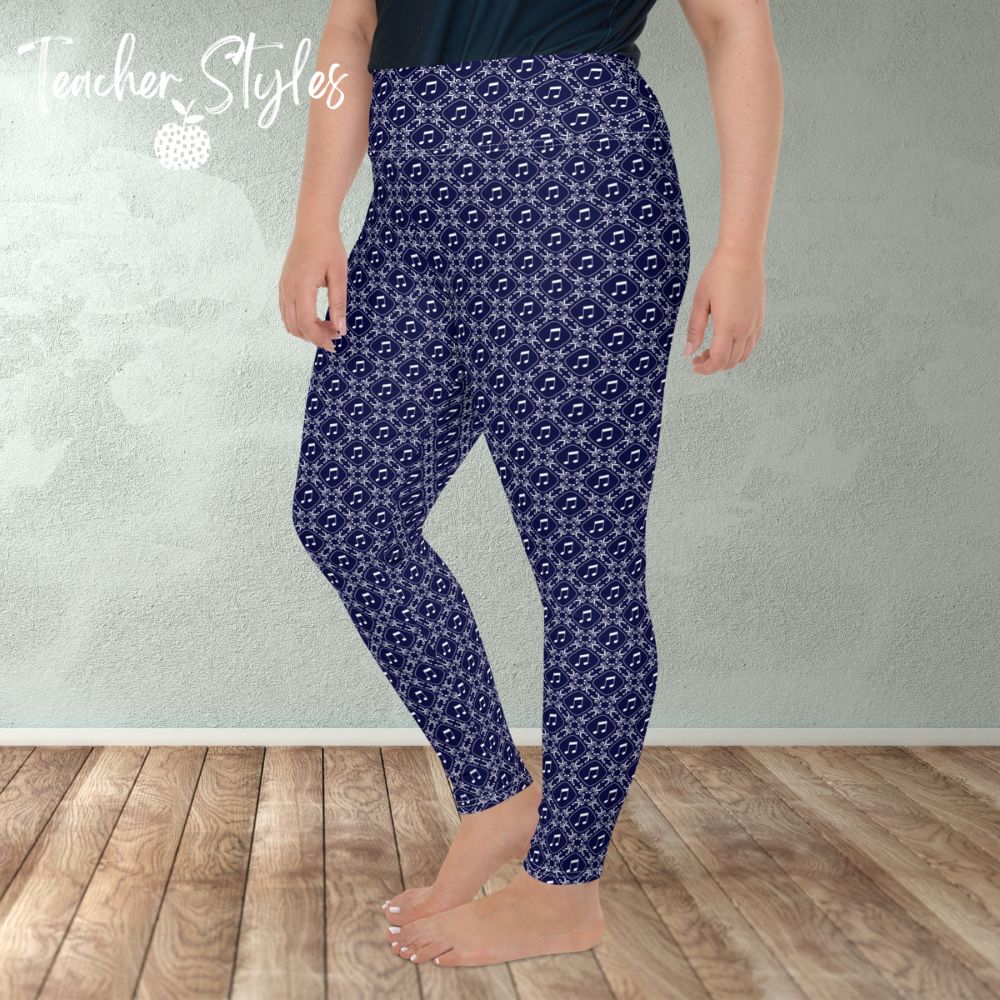 Musical Interlude plus size leggings by Teacher Syles. Model is shown from the waist down.  Leggings have deep blue background with white lattice pattern made of treble clefs. Musical notes in each treble square. side view