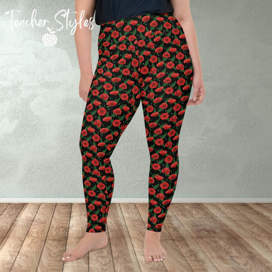 Poppies - black plus size leggings by Teacher Styles. Model shown from the waist down. Leggings have black background with vibrant red poppies and greenery.  Front viewAlso suitable for National Poppy Day, Armistice Day, Remembrance Day.