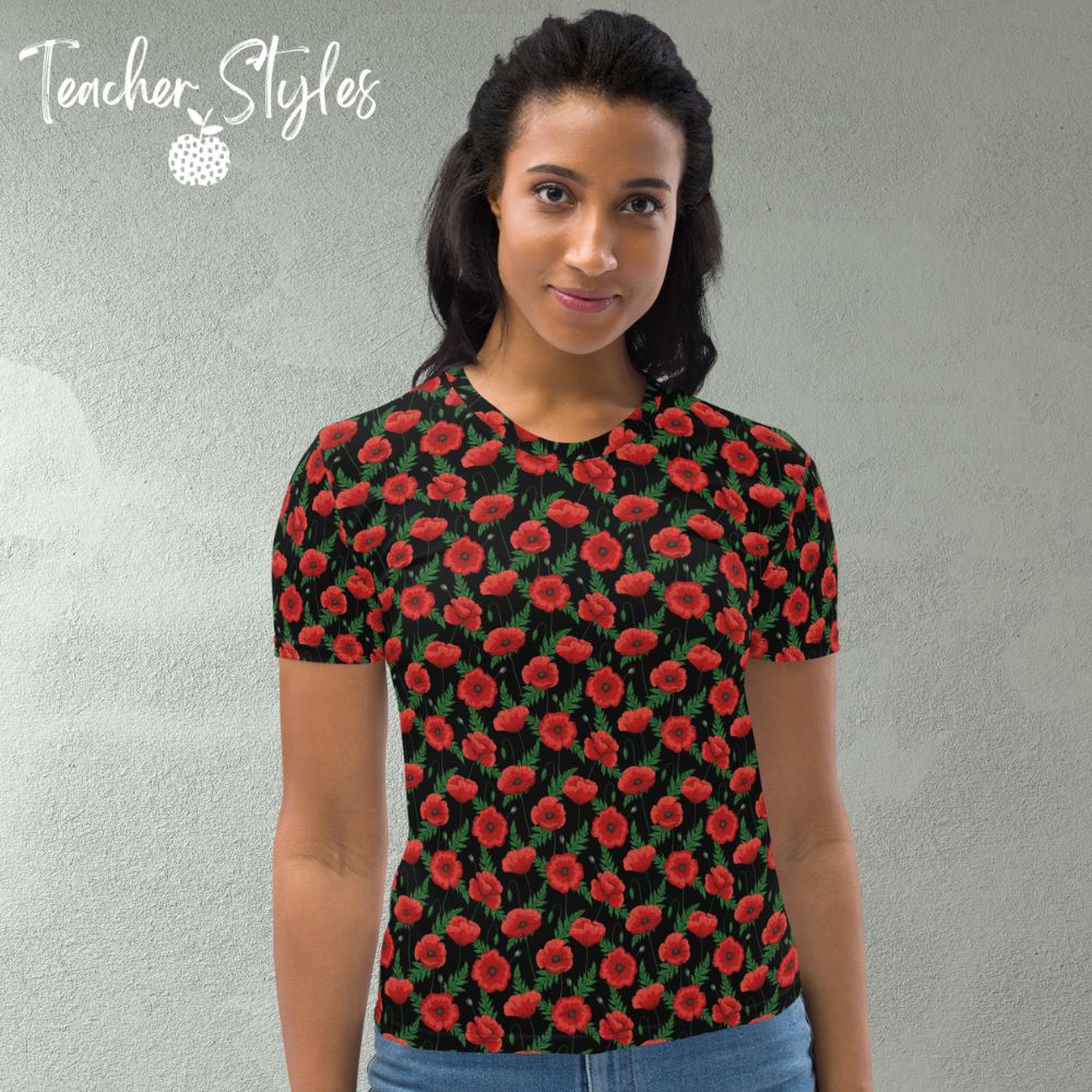 Poppies - black T-shirt by Teacher Styles. Model shown from the waist up.  T-shirt has black background with pattern of red poppies and greenery. Beautiful floral top perfect for Remembrance Day, Armistice Day and National Poppy Day. Front view.