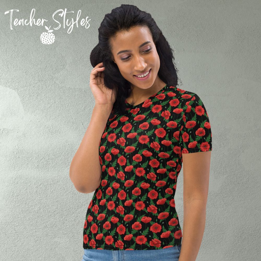 Poppies - black T-shirt by Teacher Styles. Model shown from the waist up.  T-shirt has black background with pattern of red poppies and greenery. Beautiful floral top perfect for Remembrance Day, Armistice Day and National Poppy Day. Side view.