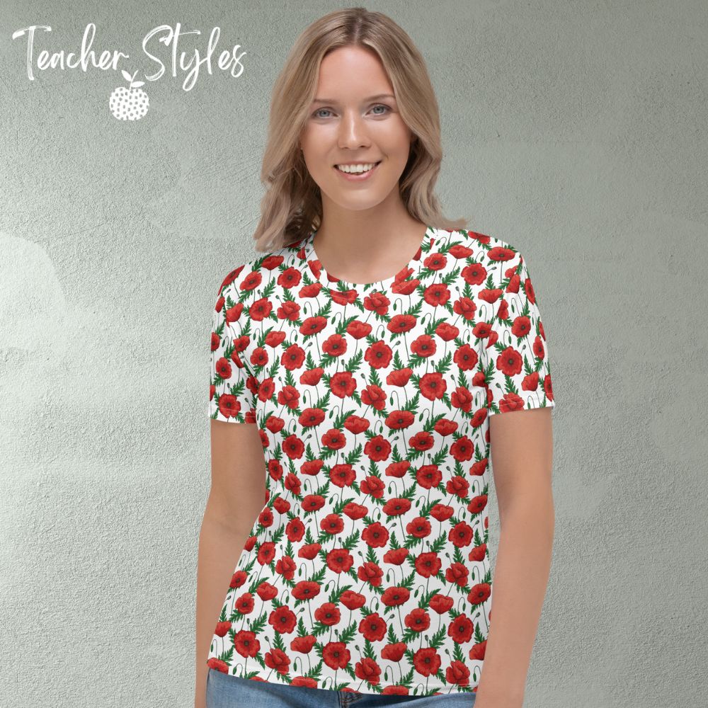 Poppies T-shirt - white by Teacher Styles. Model shown from the waist up.  T-shirt has white background with pattern of red poppies and greenery. Beautiful floral top perfect for Remembrance Day, Armistice Day and National Poppy  Day. Front view