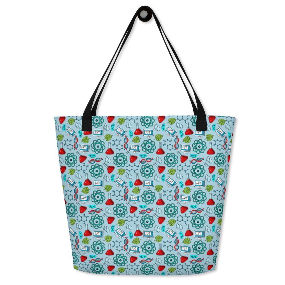 Science Tote Bag by Teacher Styles. Large light blue tote with pattern of science graphics - atoms, beakers, DNA and more! Black canvas webbed handles. Size 16" x 20". on white background.