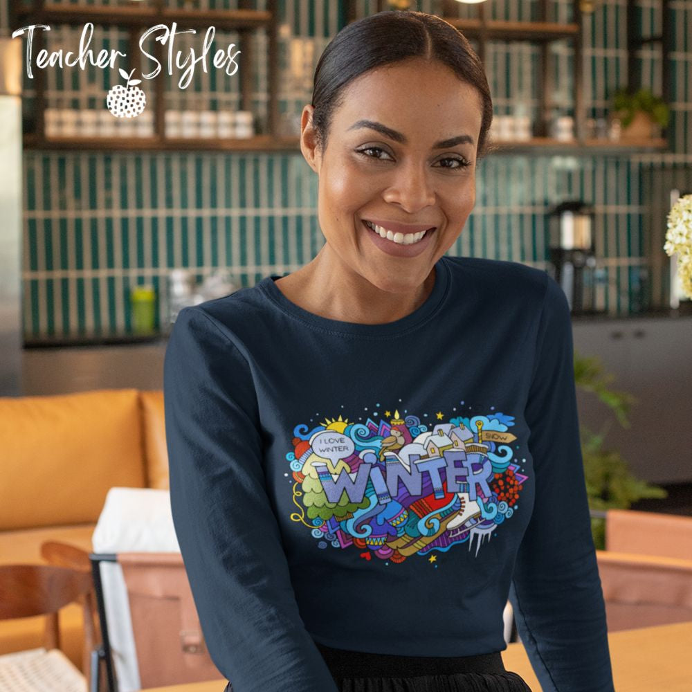 Winter Long sleeve T-shirt by Teacher Styles. Model is shown from the waist up. Navy blue tshirt with the word Winter in block letters surrounded by winter doodle of snow and skates and more!